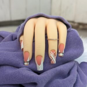 matte orange and neutral plaid press on nails with sweater textures on long coffin shape